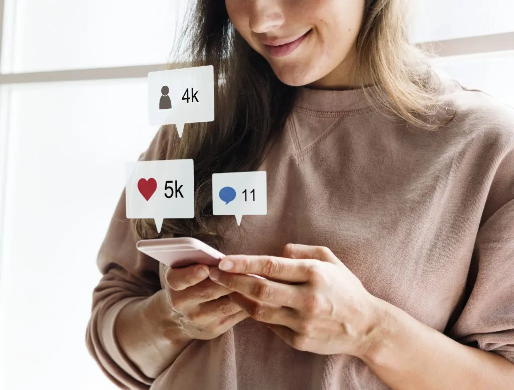 ¿Qué es el índice de popularidad en LinkedIn? 2 Mujer observando su teléfono celular.